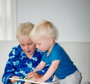 Brothers sharing book